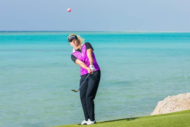 Carly Booth chips with the Red Sea at her back at the 16th hole at Royal Greens in a practice round for the inaugural Aramco Saudi Ladies International. Picture: Tristan Jones