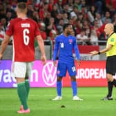 Turkish referee Cuneyt Cakir (2nd R) and England's forward Raheem Sterling debate during the FIFA World Cup Qatar 2022 qualification Group I football match between Hungary and England, at the Puskas Arena in Budapest on September 2, 2021. (Photo by ATTILA KISBENEDEK/AFP via Getty Images)