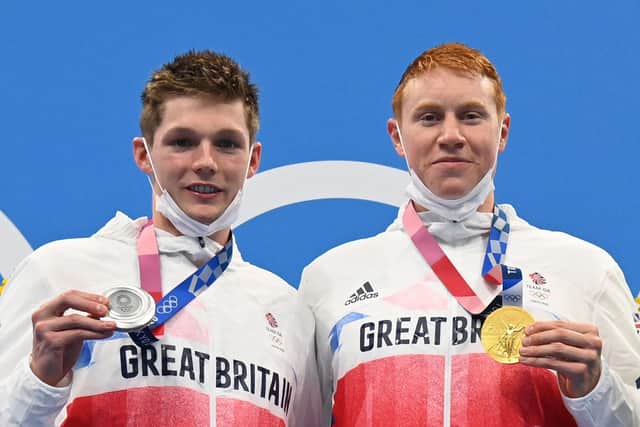 Tom Dean, right, with Duncan Scott on the podium after the the final of the men's 200m freestyle swimming event