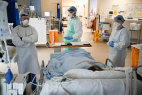 Staff at University Hospital Monklands attend to a Covid-positive patient on the ICU ward on February 5, 2021 in Airdrie, Scotland. TPhoto by Jeff J Mitchell/Getty Images