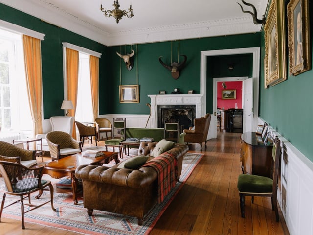 On the first floor is the sitting room with coastal views and an open fireplace.