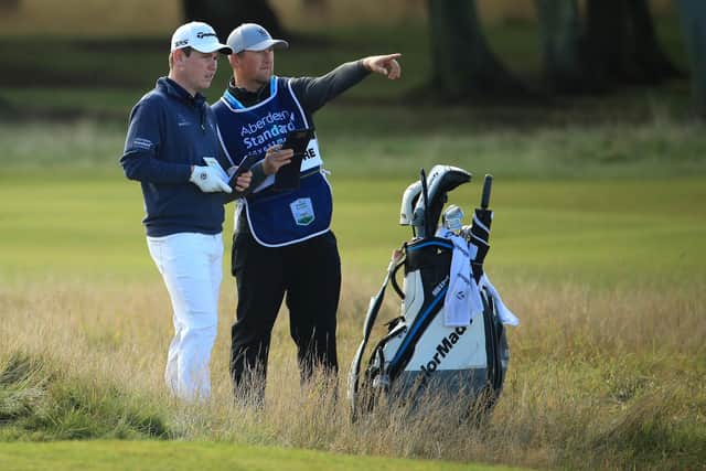 Bob MacIntyre and his new caddie Mikey Thomson ponder a shot during the Aberdeen Standard Investments Scottish Open at The Renaissance Club. Picture: Andrew Redington/Getty Images