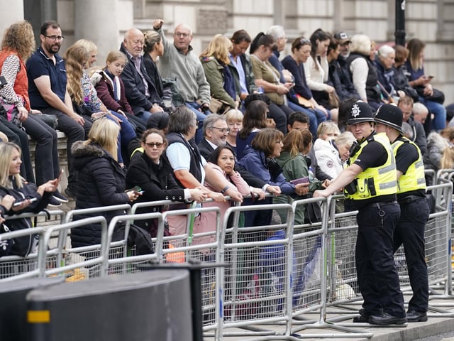 Members of the public in Westminster, central London, ahead of the ceremonial procession of the coffin of Queen Elizabeth II from Buckingham Palace to Westminster Hall, London. Picture date: Wednesday September 14, 2022.