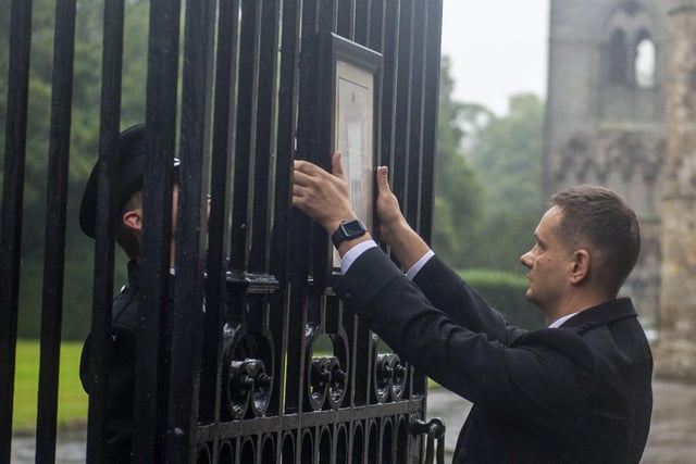 Edinburgh locals who had gathered outside the Palace of Holyroodhouse were informed of the Queen's passing when the official death notice was posted on the gates by Royal staff.