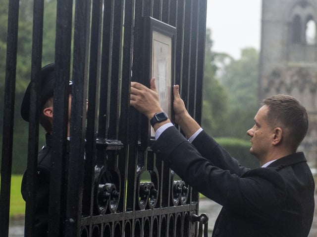 Edinburgh locals who had gathered outside the Palace of Holyroodhouse were informed of the Queen's passing when the official death notice was posted on the gates by Royal staff.