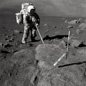 Geologist-Astronaut Harrison Schmitt, Apollo 17 lunar module pilot, uses an adjustable sampling scoop to retrieve lunar samples during the second extravehicular activity (EVA-2), at Station 5 at the Taurus- Littrow landing site.