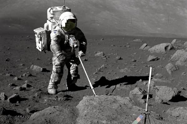 Geologist-Astronaut Harrison Schmitt, Apollo 17 lunar module pilot, uses an adjustable sampling scoop to retrieve lunar samples during the second extravehicular activity (EVA-2), at Station 5 at the Taurus- Littrow landing site.
