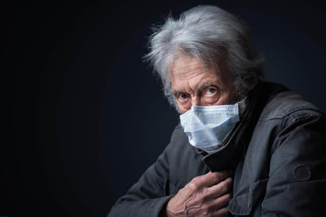 An older man wearing a protective face mask