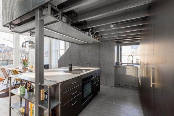 The roomy, 'industrial' styled kitchen has a versatile mezzanine space above