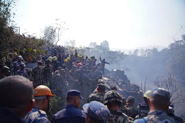 Rescuers gather at the site of a plane crash in Pokhara on January 15, 2023. - An aircraft with 72 people on board crashed in Nepal on January 15, Yeti Airlines and a local official said. (Photo by Yunish Gurung / AFP) (Photo by YUNISH GURUNG/AFP via Getty Images)