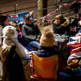 Royalists sit together alongside the planned route of King Charles III near Buckingham Palace on May 4 2023.