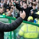 Celtic manager Ange Postecoglou takes the adulation of fans during a victory over Rangers.