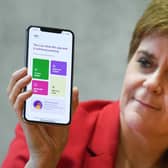 First Minister Nicola Sturgeon with the Protect Scotland app. (Photo by Jeff J Mitchell/Getty Images)