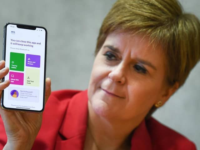 First Minister Nicola Sturgeon with the Protect Scotland app. (Photo by Jeff J Mitchell/Getty Images)