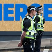 Police officers can be role models to young people who have few others to talk to about their problems (Picture: Robert Perry/AFP via Getty Images)