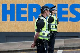 Police officers can be role models to young people who have few others to talk to about their problems (Picture: Robert Perry/AFP via Getty Images)