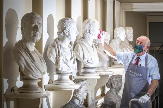 Danny McIlwraith inspects some of the Victorian marble and plaster busts on display at Bonhams Edinburgh during the Dunrobin Attic Sale, an auction of hundreds of items found in the attics and cellars at Dunrobin Castle.