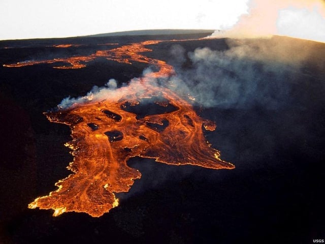 This aerial image released by the US Geological Survey (USGS) courtesy of the National Weather Service, shows the lava in the summit caldera of Mauna Loa in Hawaii, which is erupting for the first time in nearly 40 years. - Hawaii's Mauna Loa, the largest active volcano in the world, has erupted for the first time in nearly 40 years, US authorities said, as emergency crews went on alert early Monday. Photo via Getty