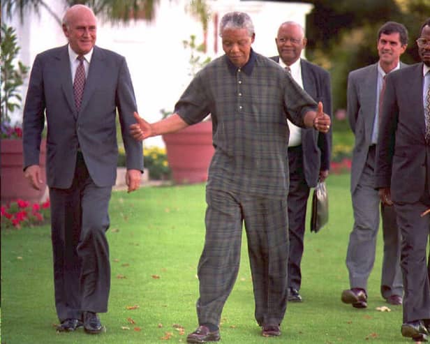 FW de Klerk, left, walks with Nelson Mandela, centre, and Zulu leader Mangosuthu Buthelezi in 1995 (Picture: Guy Tillim/AFP via Getty Images)