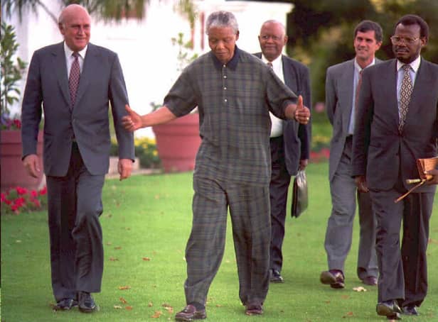FW de Klerk, left, walks with Nelson Mandela, centre, and Zulu leader Mangosuthu Buthelezi in 1995 (Picture: Guy Tillim/AFP via Getty Images)
