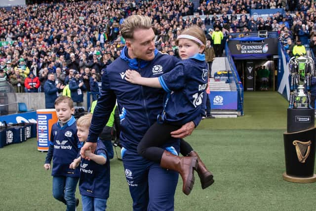 Stuart Hogg walks out with daughter Olivia May Hogg and sons Archie William and George on his 100th cap during a Guinness Six Nations match between Scotland and Ireland at BT Murrayfield.