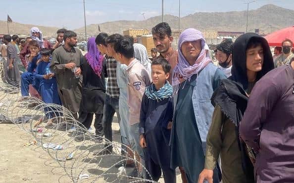 Afghans wait around the Kabul International Airport as they try to flee the Afghan capital of Kabul. Picture: Haroon Sabawoon/Anadolu Agency via Getty Images