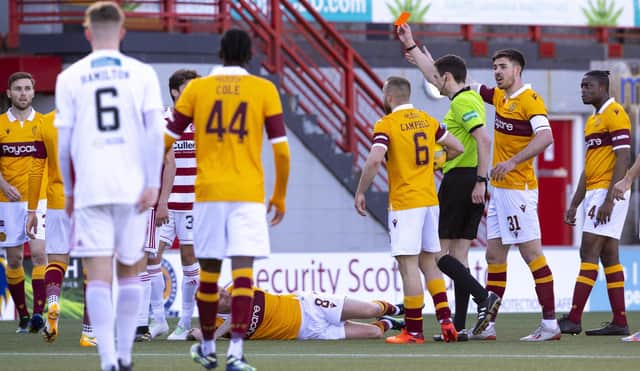 Ronan Hughes of Hamilton is sent off by referee Kevin Clancy. Motherwell won the match 1-0.