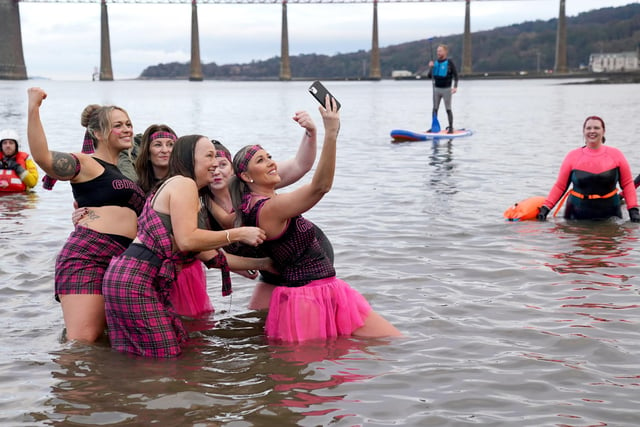 People take part in the Loony Dook New Year's Day dip in the Firth of Forth at South Queensferry