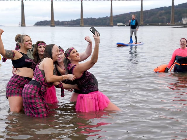People take part in the Loony Dook New Year's Day dip in the Firth of Forth at South Queensferry