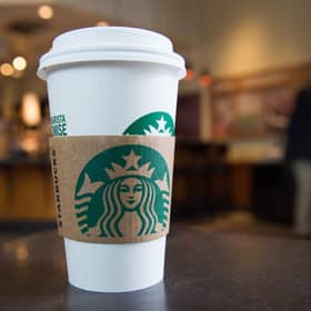 A Starbucks coffee cup (Photo by SAUL LOEB/AFP via Getty Images)