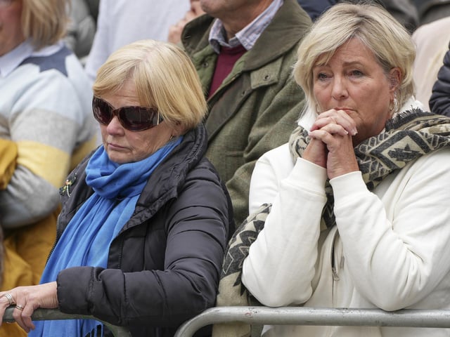 Members of the public listen to the service of the funeral of Queen Elizabeth II in central London. Picture date: Monday September 19, 2022.