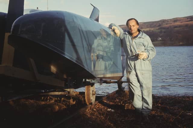 Donald Campbell's climbs down from his jet hydroplane 'Bluebird' at Coniston Water, Cumberland, while attempting to break the world water speed record.
