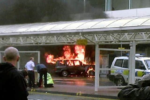 Flames rise from a jeep after the terror attack on Glasgow Airport in 2007. Picture: PA