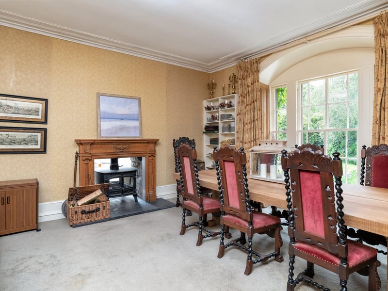 There is a log-burning fire in the elegant dining room