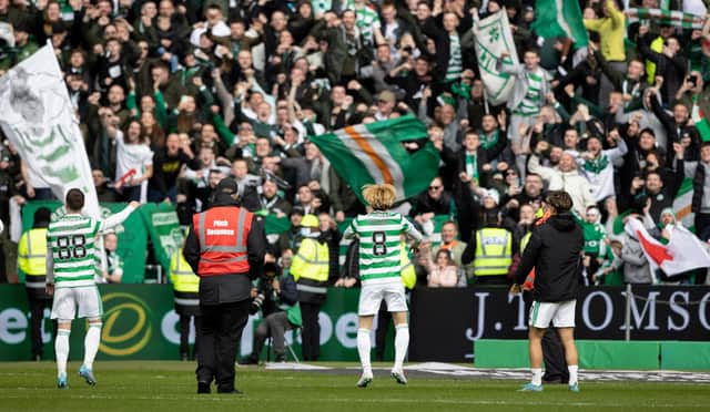 Celtic's Kyogo Furuhashi (centre), Josip Juranovic (left) and Jota celebrate with the Celtic support at full-time of their 7-0 win over St Johnstone on Saturday and manager Ange Postecoglou says the most important measure for his team is how happy fans are trooping down London Road at the end of games. (Photo by Craig Williamson / SNS Group)