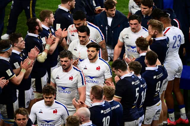 Scotland applaud France's players off the pitch in Paris after beating them 27-23 in the final match of the 2021 Six Nations. (Photo by MARTIN BUREAU/AFP via Getty Images)