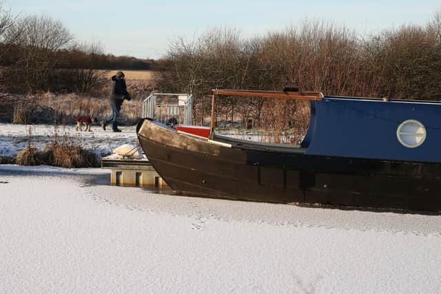 A frost and snow covered Forth and Clyde Canal near to the Kelpies in Falkirk, Central Scotland.
