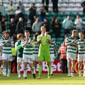 The triumphant Celtic team applaud their fans after the 3-0 win over Dundee.