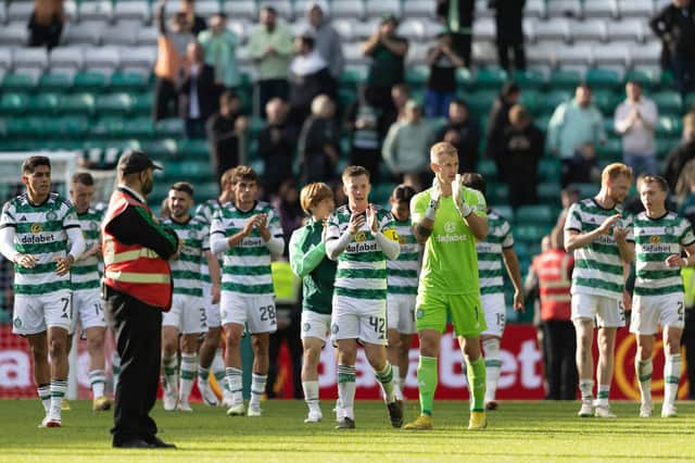 The triumphant Celtic team applaud their fans after the 3-0 win over Dundee.