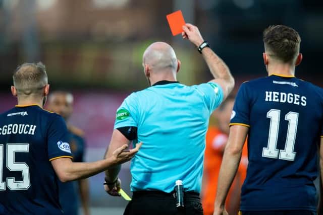Referee Bobby Madden shows a yellow and then the red card to Aberdeen's Funso Ojo during a cinch Premiership match between Dundee United and Aberdeen at Tannadice Park, on November 20, 2021, in Dundee, Scotland. (Photo by Mark Scates / SNS Group)