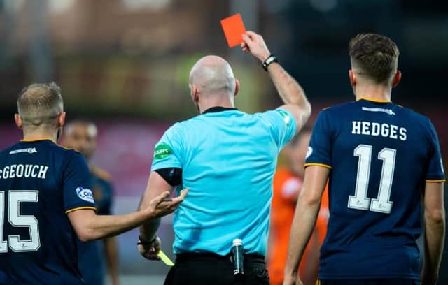 Referee Bobby Madden shows a yellow and then the red card to Aberdeen's Funso Ojo during a cinch Premiership match between Dundee United and Aberdeen at Tannadice Park, on November 20, 2021, in Dundee, Scotland. (Photo by Mark Scates / SNS Group)