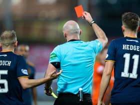 Referee Bobby Madden shows a yellow and then the red card to Aberdeen's Funso Ojo during a cinch Premiership match between Dundee United and Aberdeen at Tannadice Park, on November 20, 2021, in Dundee, Scotland. (Photo by Mark Scates / SNS Group)