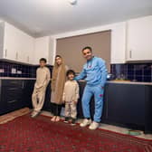 Ammaduddin Sidiqi with three of his children in their new kitchen at Calton Village
