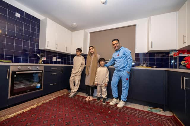 Ammaduddin Sidiqi with three of his children in their new kitchen at Calton Village