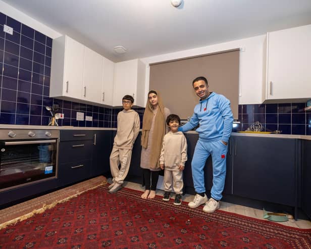 Ammaduddin Sidiqi with three of his children in their new kitchen at Calton Village
