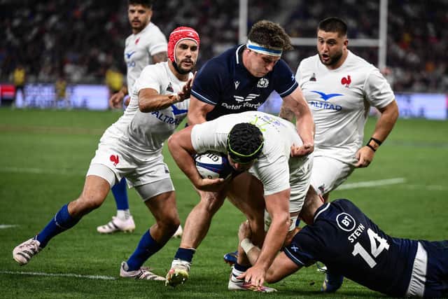 Rory Darge feels the full force of the French defence during Scotland's narrow defeat in Saint-Etienne.