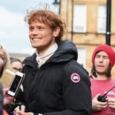 Sam Heughan is approached by fans as Outlander filming takes place in Glasgow (Getty Images)