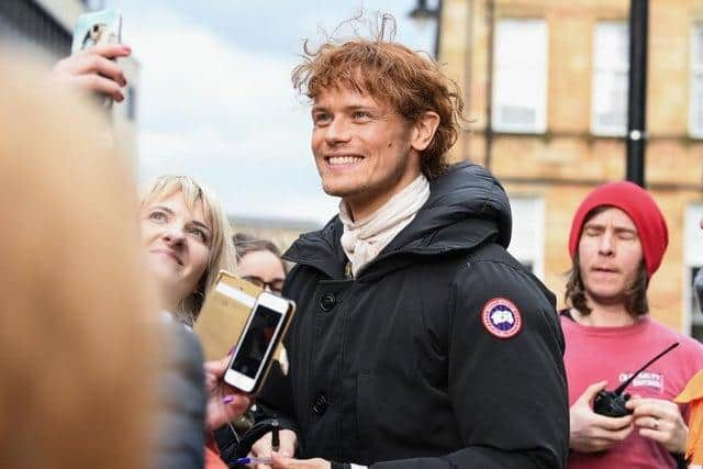 Sam Heughan is approached by fans as Outlander filming takes place in Glasgow (Getty Images)