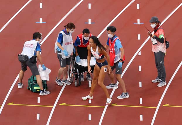 Katarina Johnson-Thompson receives medical attention after injuring her right calf during the heptathlon 200m. Picture: Rob Carr/Getty Images