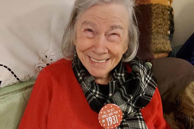 Betty Mcgill, otherwise known as 'old Betty' to some of the Tesco staff who deliver food to her, smiling on her birthday wearing a badge saying 'All the best things were made in 1931' picture: supplied